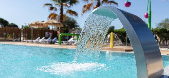 The aquatic area with water jet of the campsite les Amandiers, in Castelnau de Guers in the Hérault